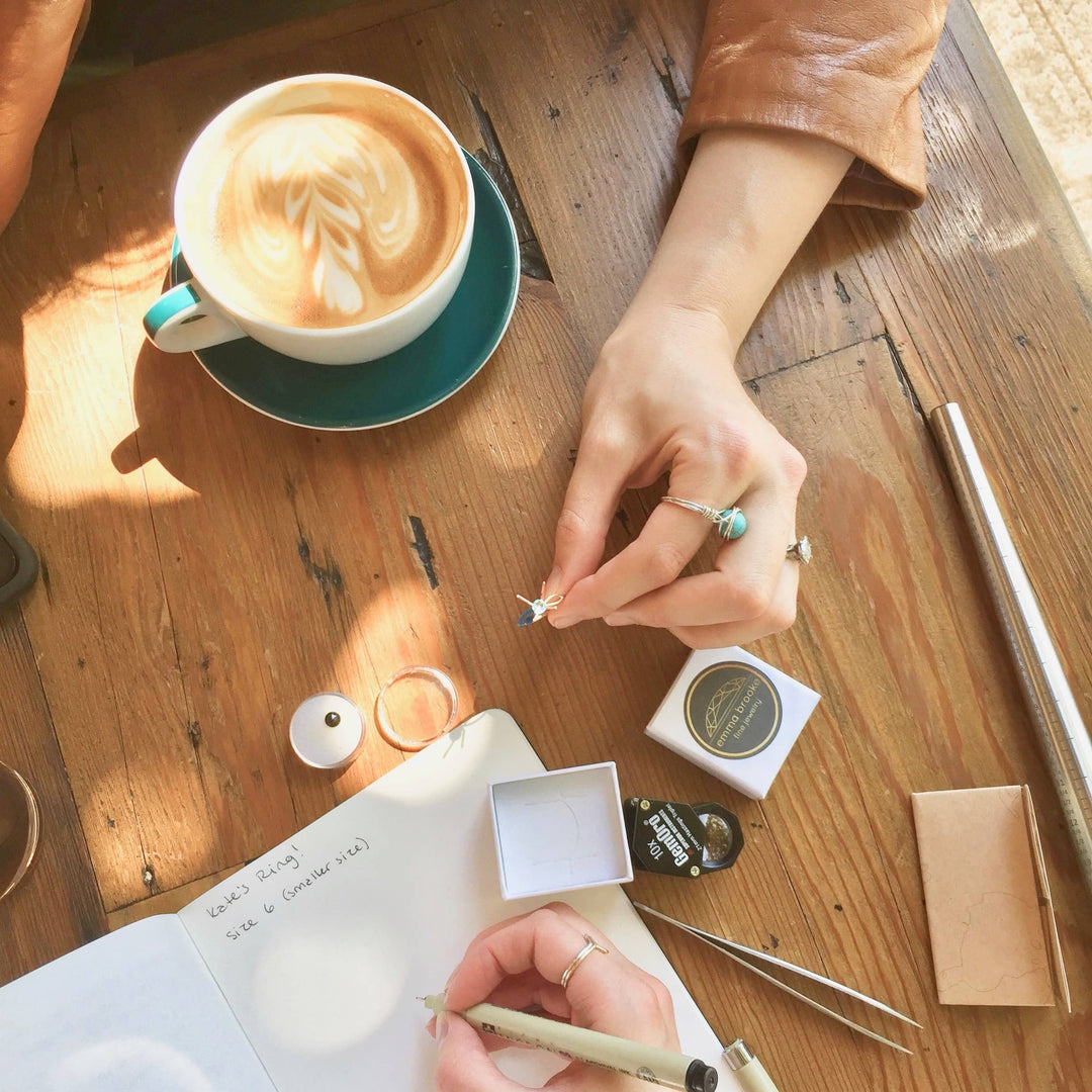 custom jewelry design meeting in coffeeshop, designing custom engagement ring in vancouver wa. Jewelry business flat lay photo