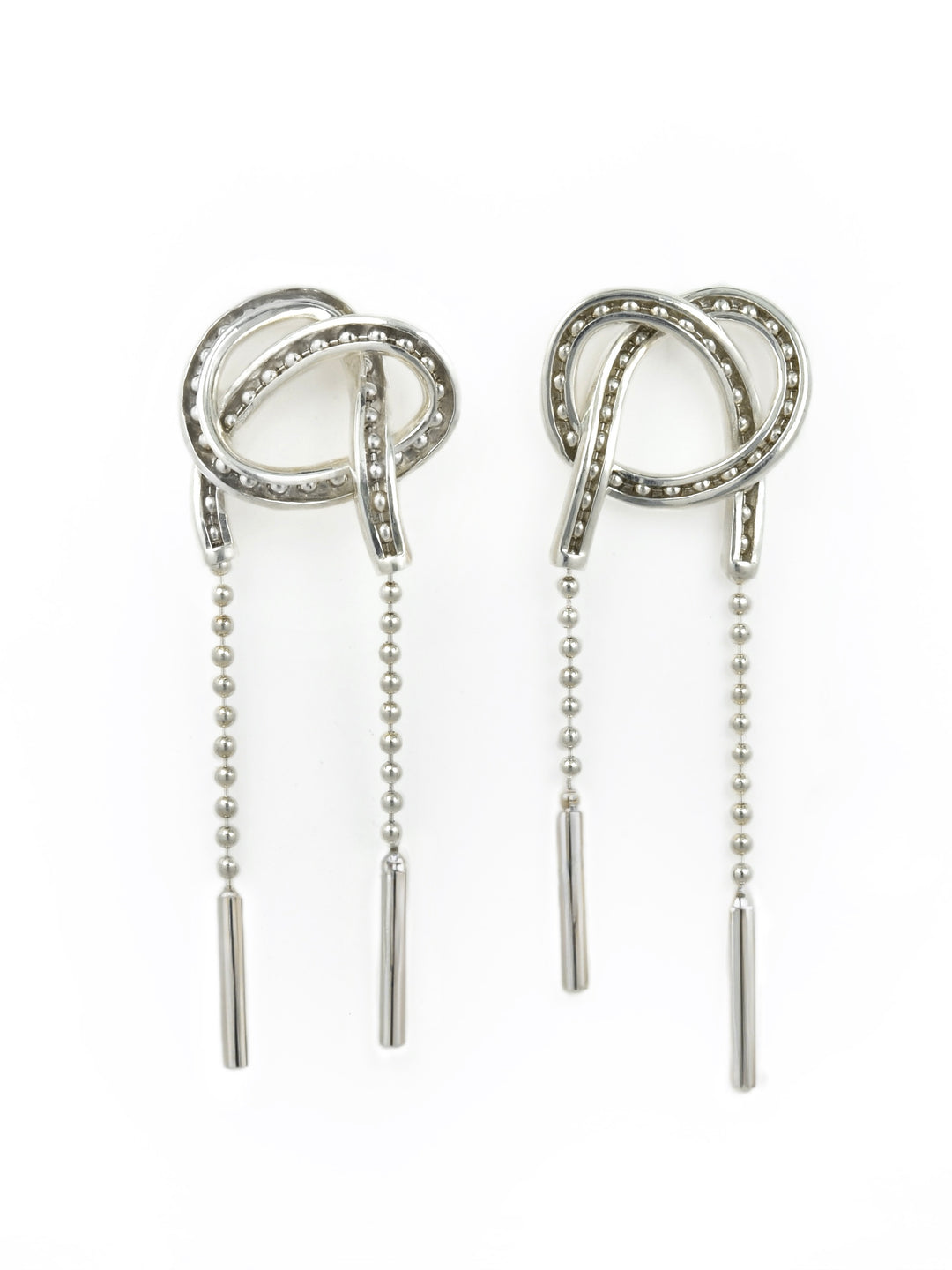Pair of kinetic silver earrings with adjustable beaded chain on a white background