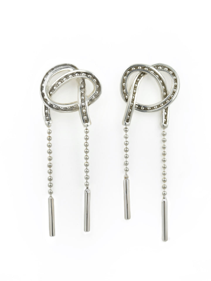 Pair of kinetic silver earrings with adjustable beaded chain on a white background