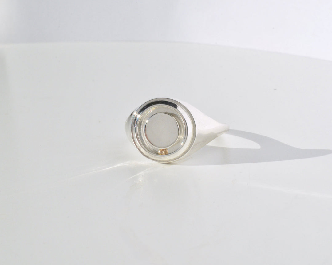 the rolling orbit signet ring in silver and gold