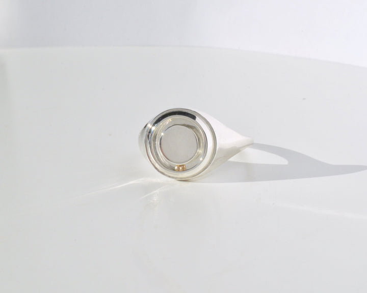 the rolling orbit signet ring in silver and gold