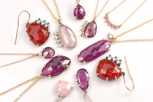 flat lay photography of pink and red rose cut gemstone jewelry by Emma Brooke