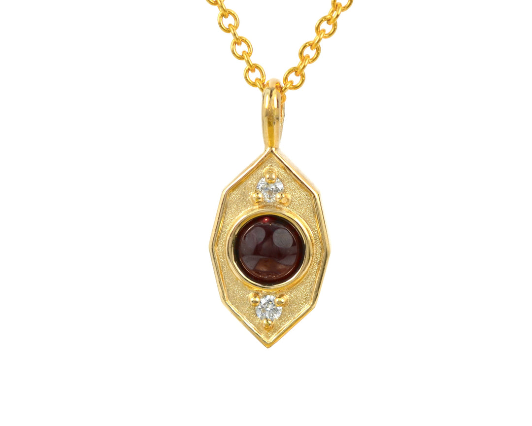 A gold pendant necklace featuring an interactive kinetic gold charm with a central spherical dark red garnet and two small diamond accent stones, suspended from a delicate gold chain against a plain white background.