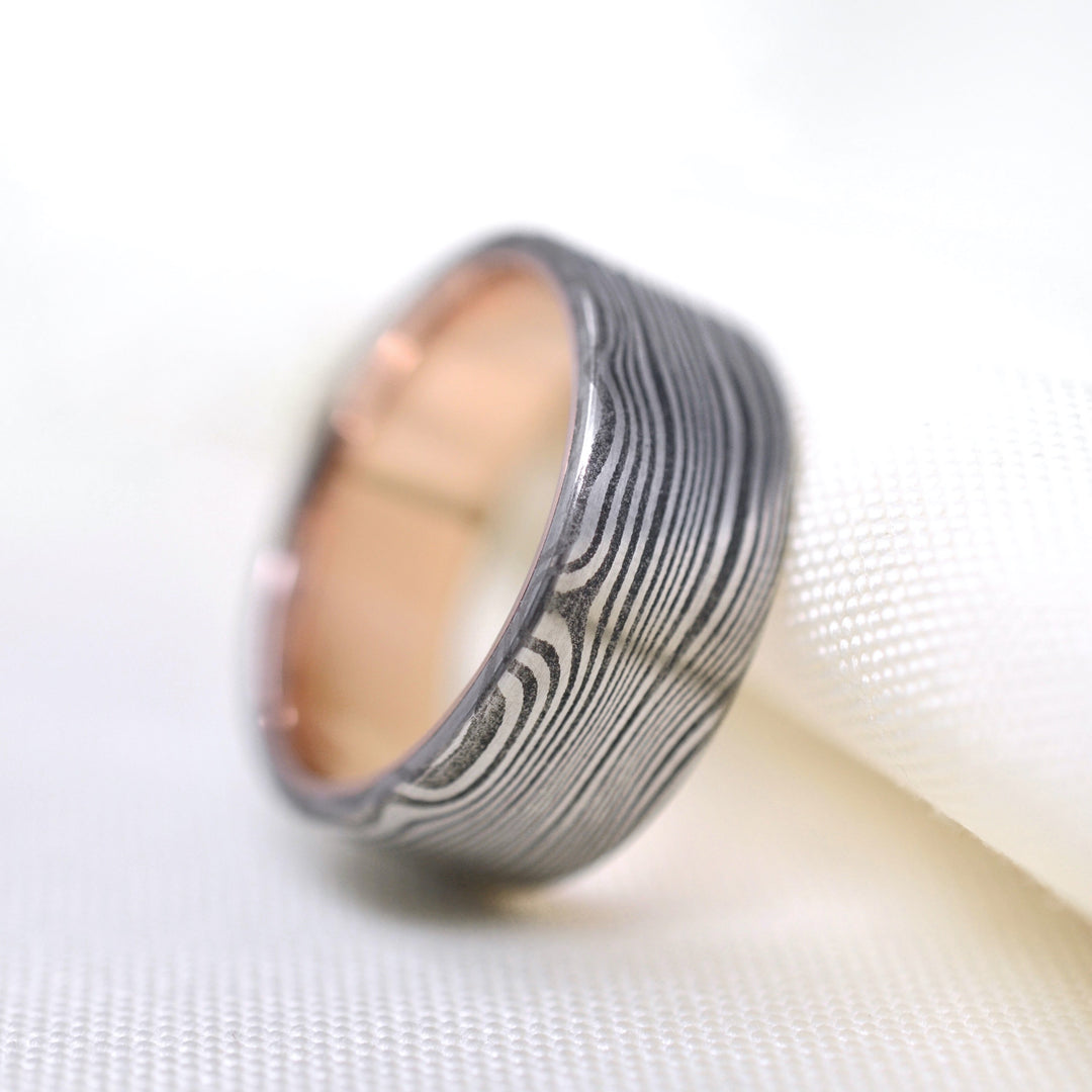 Hand forged damascus and rose gold wedding ring, made by Alex Horn Knives and Emma Brooke Jewelry in Portland, OR.