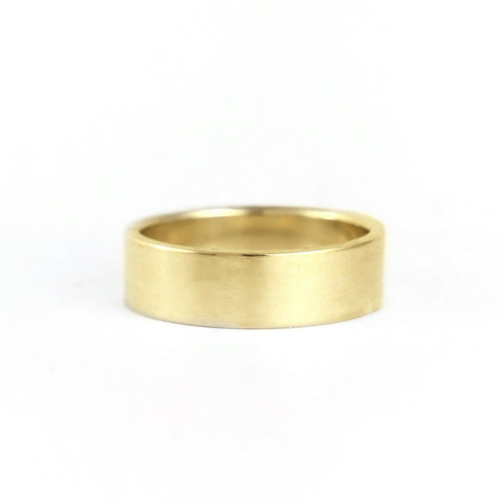Plain flat unisex or men's wedding band shown in 14k  yellow gold. Handmade in recycled silver or 14k recycled gold. Made in Portland, OR by Emma Brooke Jewelry.