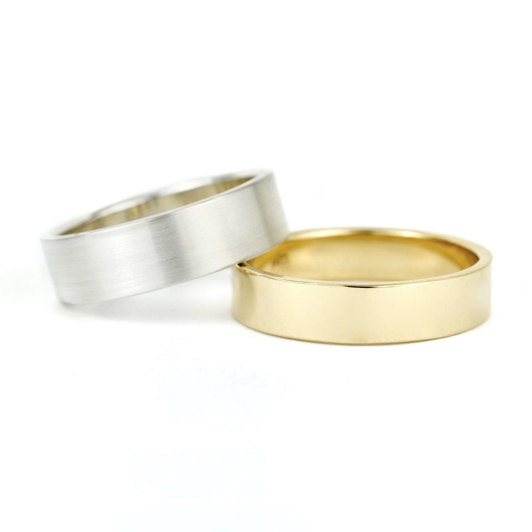 Plain flat unisex or men's wedding bands in 14k white gold and yellow gold. Handmade in recycled silver or 14k recycled gold. Made in Portland, OR by Emma Brooke Jewelry.