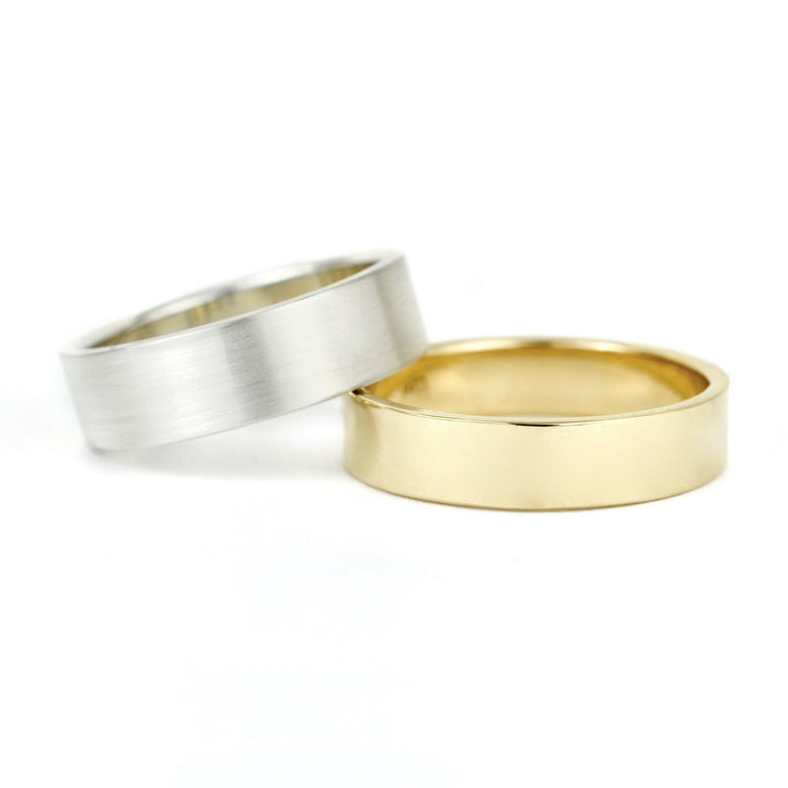 Plain flat unisex or men's wedding bands in 14k white gold and yellow gold. Handmade in recycled silver or 14k recycled gold. Made in Portland, OR by Emma Brooke Jewelry.